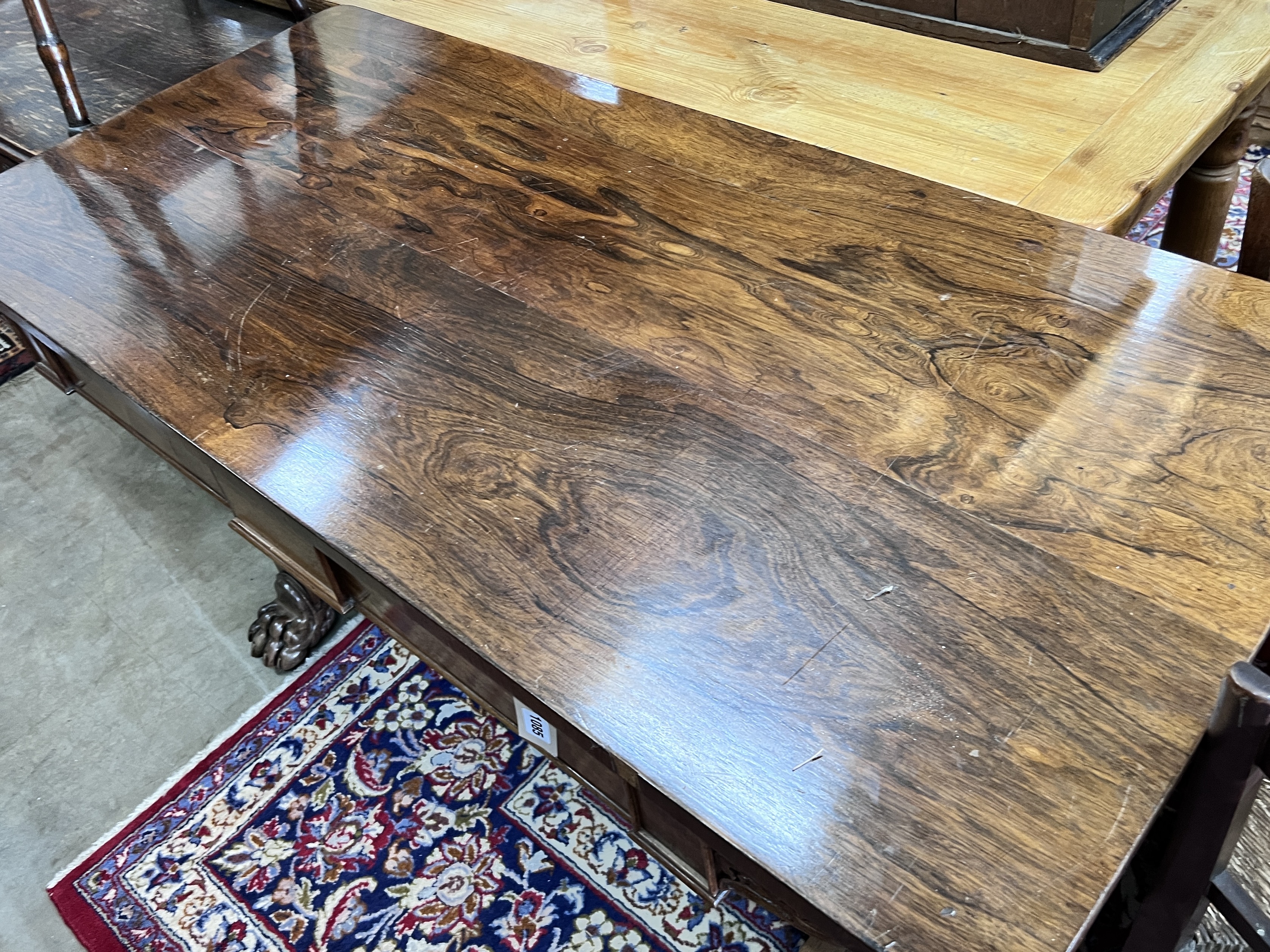 A Victorian rosewood two drawer library table, width 143cm, depth 68cm, height 77cm